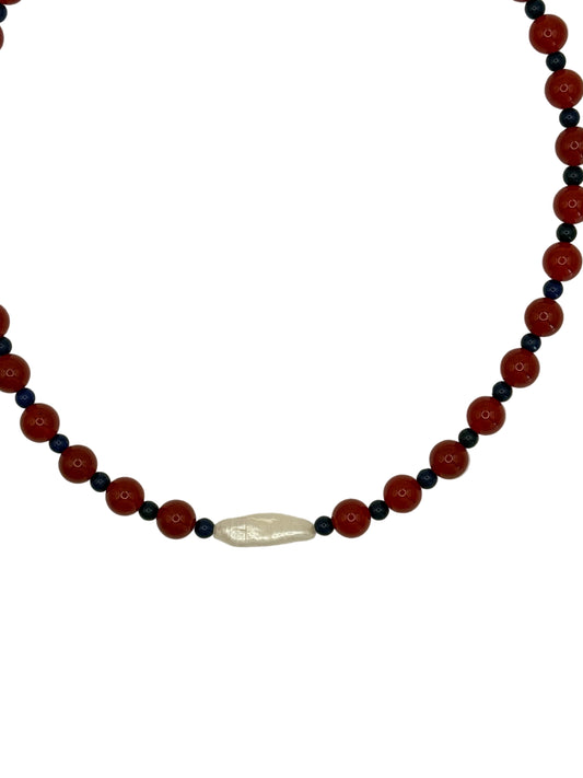 Necklace with red and black beads on a white background