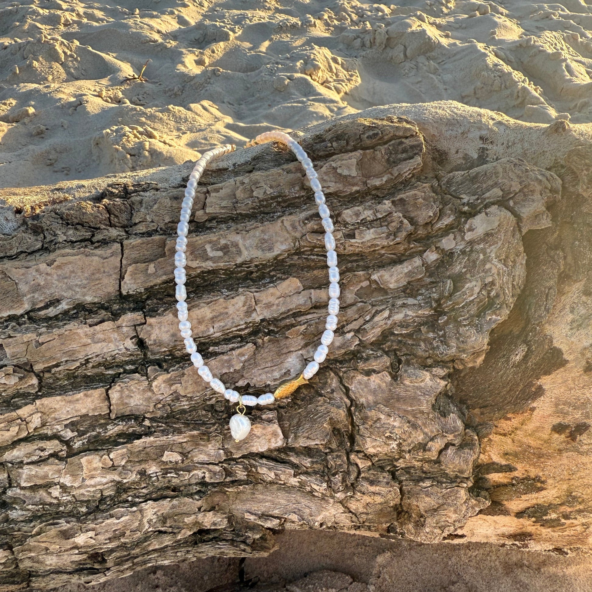Pearl bracelet on a textured stone surface
