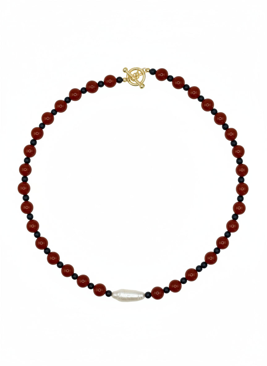 Necklace with red and black beads on a white background