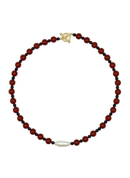 Necklace with red and black beads on a white background